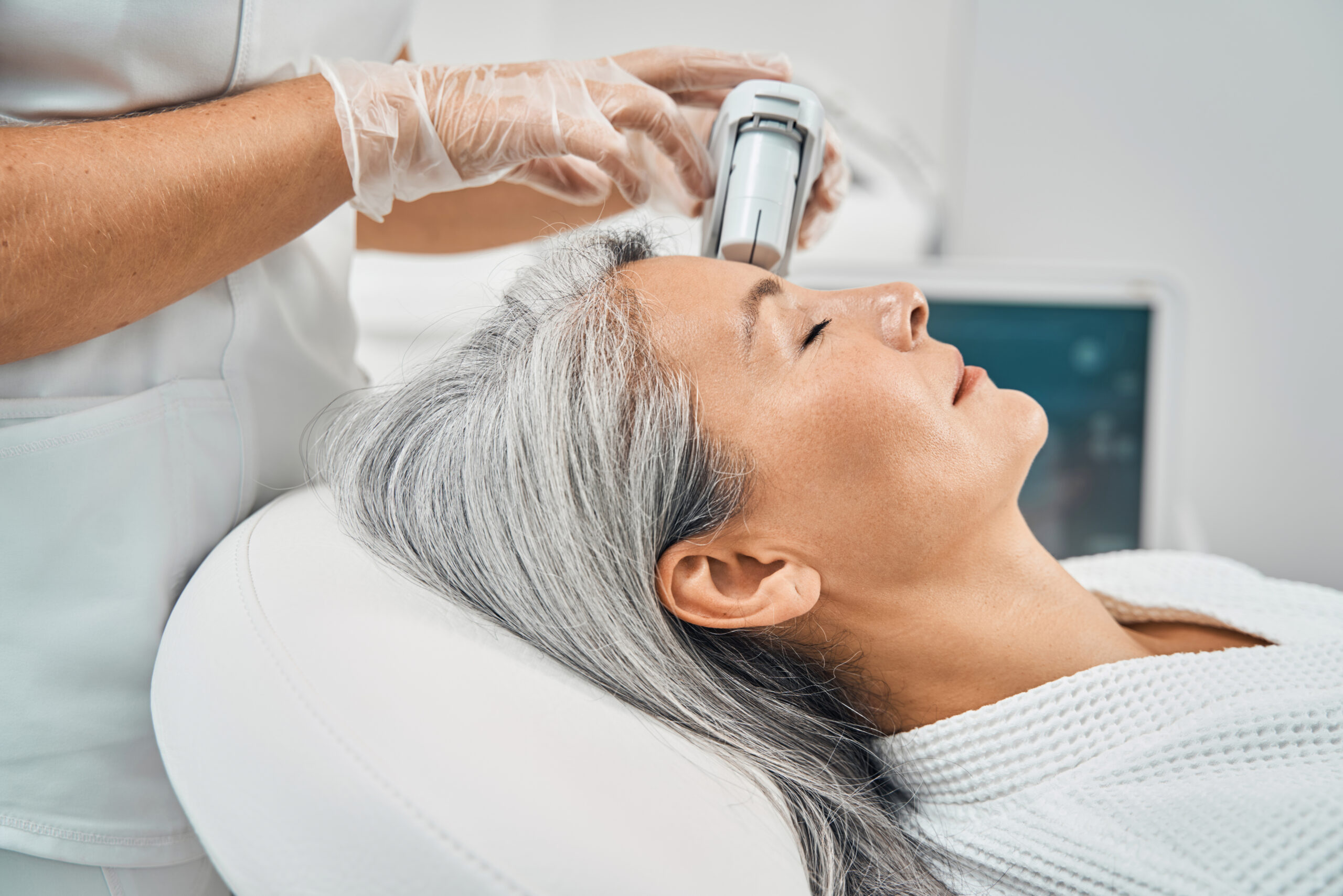 Close up of relaxed woman keeping her eyes closed while being in beauty salon